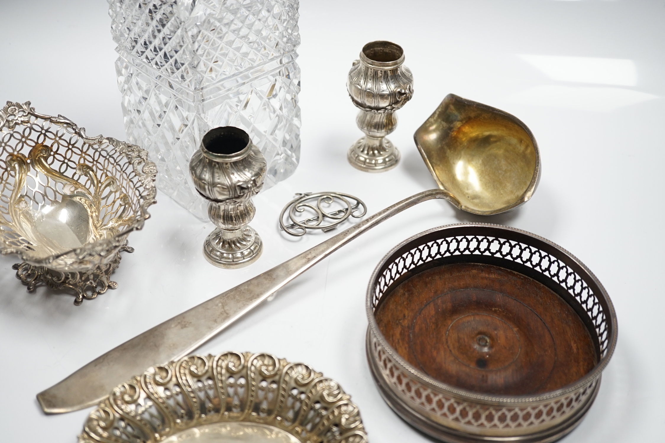 Assorted silver and white metal items including a pair of late Victorian pierced silver bonbon dishes, a pierced silver small bowl, a modern silver wine coaster, a silver belt buckle, white metal belt buckle, two contine